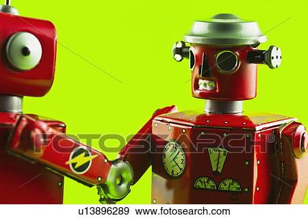 Toy robots shaking hands View Large Photo Image Stock Photo - Toy robots shaking hands. Fotosearch