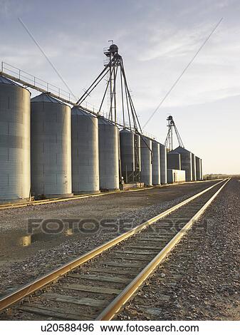 Stock Photograph - Train tracks beside silos. Fotosearch