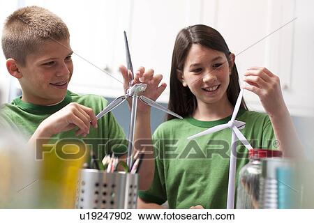 Stock Image - Two children making model windmills. Fotosearch
