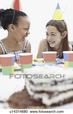 Stock Image - Two girls at a birthday party. Fotosearch