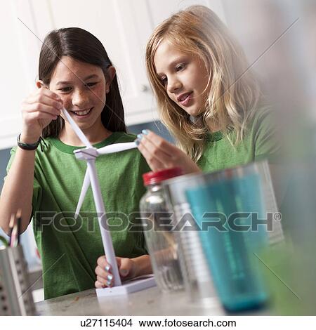 Picture - Two girls looking at model windmill. Fotosearch