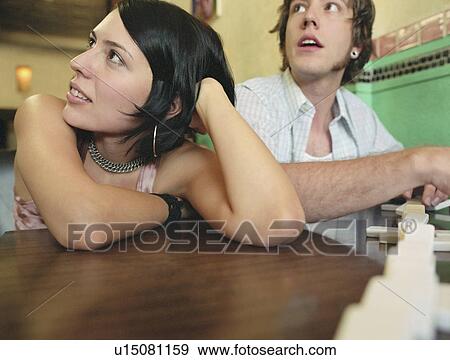Stock Photo - Two people playing dominoes. Fotosearch