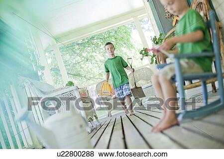 Two young boys on porch View Large Photo Image Stock Photo - Two young boys on porch. Fotosearch