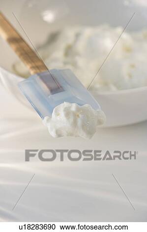 Stock Image - Whipped cream on rubber spatula. Fotosearch