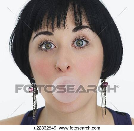 Stock Photo - Woman blowing a bubble with bubble gum. Fotosearch