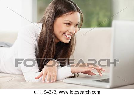 Stock Image - Woman browsing the internet. Fotosearch