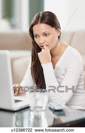 Stock Image - Woman browsing the internet. Fotosearch
