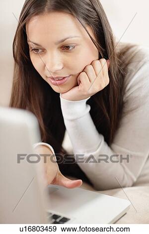 Woman browsing the internet View Large Photo Image Stock Photo - Woman browsing the internet. Fotosearch