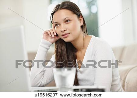 Stock Photo - Woman browsing the internet. Fotosearch