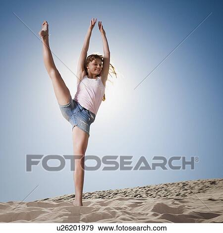 Woman dancing in sand View Large Photo Image Stock Photo - Woman dancing in sand. Fotosearch