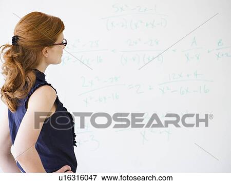 Woman doing math equations View Large Photo Image Stock Photo - Woman doing math equations. Fotosearch