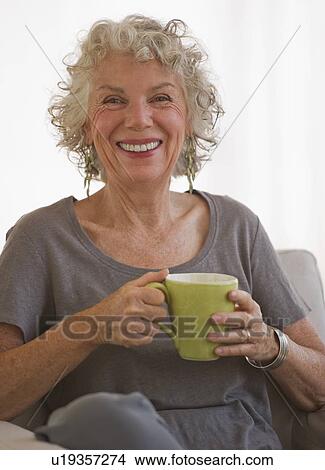 Woman drinking a cup of coffee View Large Photo Image Picture - Woman drinking a cup of coffee. Fotosearch