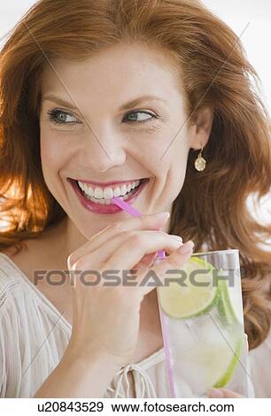 Stock Photo - Woman drinking lime water. Fotosearch