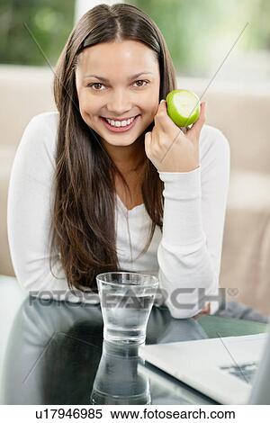 Stock Photography - Woman eating an apple. Fotosearch