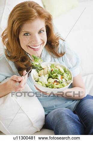 Stock Image - Woman eating salad. Fotosearch