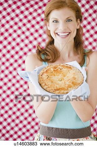 Woman holding a freshly baked pie View Large Photo Image Stock Image - Woman holding a freshly baked pie. Fotosearch