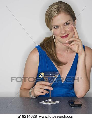 Woman holding a martini glass View Large Photo Image Stock Photo - Woman holding a martini glass. Fotosearch