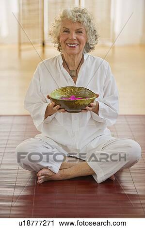 Woman holding bowl of flower petals View Large Photo Image Stock Image - Woman holding bowl of flower petals. Fotosearch
