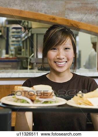 Woman holding tray of food View Large Photo Image Stock Image - Woman holding tray of food. Fotosearch