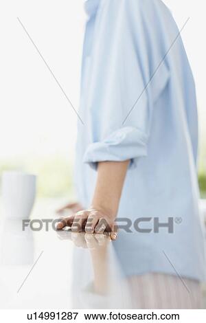 Woman leaning on kitchen counter View Large Photo Image Stock Photo - Woman leaning on kitchen counter. Fotosearch