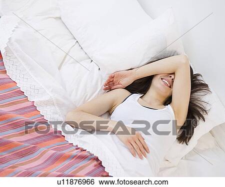 Woman lying in bed View Large Photo Image Stock Photograph - Woman lying in bed. Fotosearch