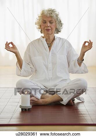 Woman meditating View Large Photo Image Stock Image - Woman meditating. Fotosearch