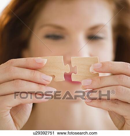 Woman putting puzzle pieces together View Large Photo Image Stock Image - Woman putting puzzle pieces together. Fotosearch