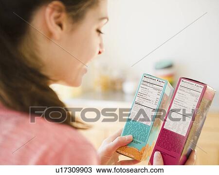 Woman reading nutrition facts on food packaging View Large Photo Image Stock Image - Woman reading nutrition facts on food packaging. Fotosearch