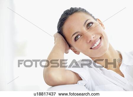 Woman relaxing on couch View Large Photo Image Stock Photo - Woman relaxing on couch. Fotosearch