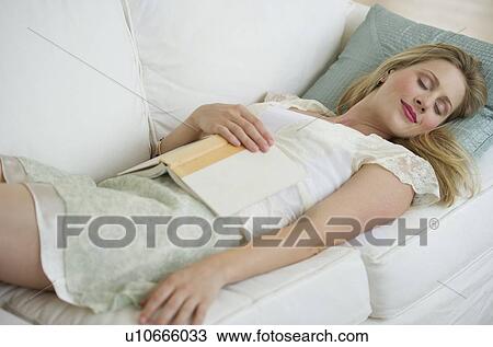 Woman resting on couch View Large Photo Image Stock Image - Woman resting on couch. Fotosearch