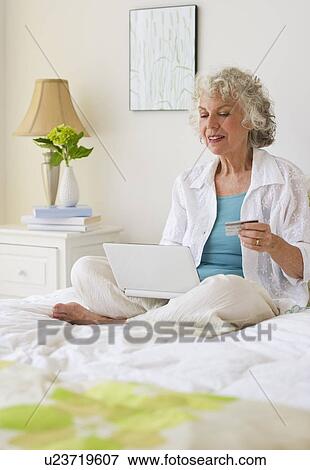 Woman shopping online View Large Photo Image Stock Photo - Woman shopping online. Fotosearch