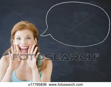 Woman standing in front of a speech bubble View Large Photo Image Stock Photograph - Woman standing in front of a speech bubble. Fotosearch