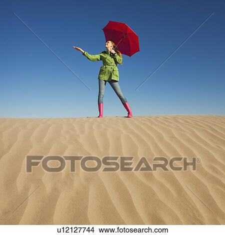 Woman waiting for rain in the desert View Large Photo Image Picture - Woman waiting for rain in the desert. Fotosearch