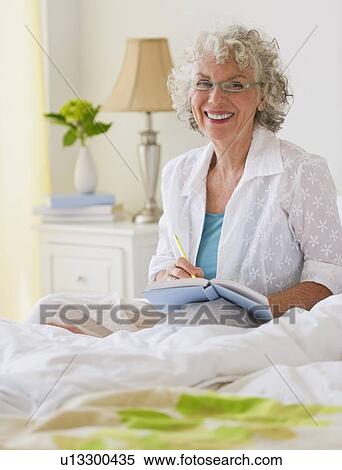 Woman writing in her journal View Large Photo Image Stock Photography - Woman writing in her journal. Fotosearch