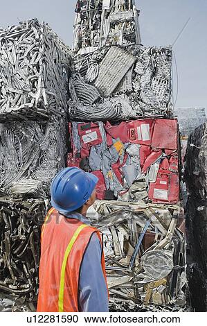 Stock Image - Worker at recycling plant. Fotosearch