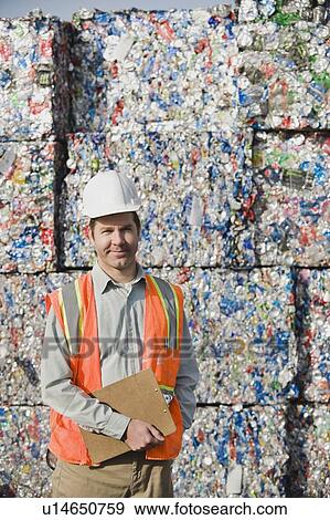 Worker standing in front of crushed aluminum cans View Large Photo Image Stock Photo - Worker standing in front of crushed aluminum cans. Fotosearch