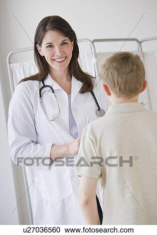 Young boy and doctor in examination room View Large Photo Image Stock Image - Young boy and doctor in examination room. Fotosearch