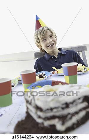 Picture - Young boy at a birthday party. Fotosearch