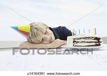 Young boy daydreaming about birthday cake View Large Photo Image Stock Image - Young boy daydreaming about birthday cake. Fotosearch