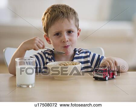 Stock Image - Young boy eating cereal. Fotosearch