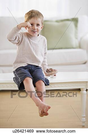 Young boy eating ice cream View Large Photo Image Stock Photo - Young boy eating ice cream. Fotosearch