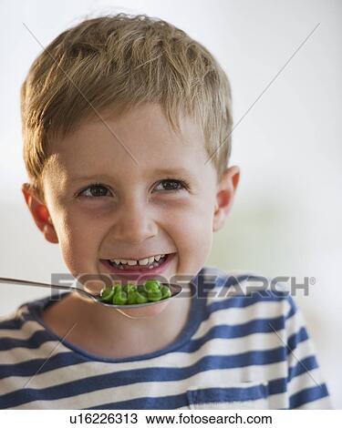 Young boy eating peas View Large Photo Image Stock Image - Young boy eating peas. Fotosearch