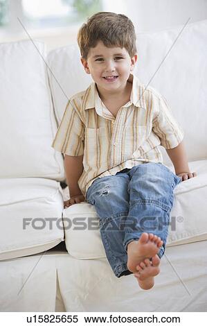 Young boy sitting on couch View Large Photo Image Stock Photography - Young boy sitting on couch. Fotosearch