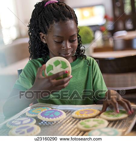 Stock Image - Young girl baking cookies. Fotosearch