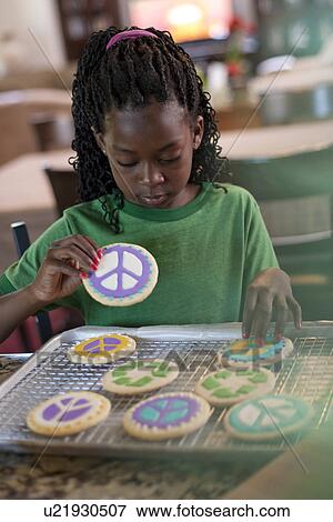 Stock Photo - Young girl baking cookies. Fotosearch