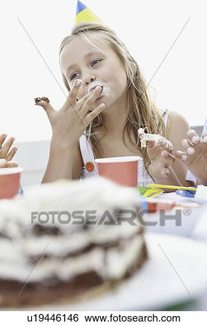 Young girl eating birthday cake View Large Photo Image Stock Photograph - Young girl eating birthday cake. Fotosearch