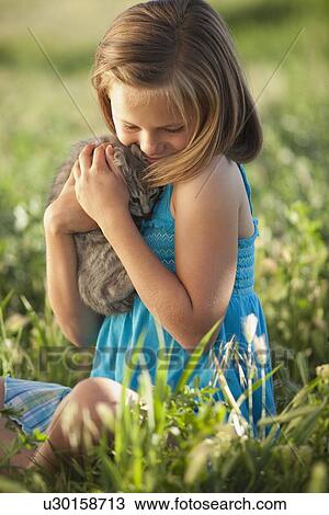Young girl holding a kitten View Large Photo Image Stock Image - Young girl holding a kitten. Fotosearch