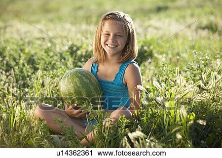 Young girl holding a watermelon View Large Photo Image Stock Image - Young girl holding a watermelon. Fotosearch