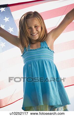 Young girl holding American flag View Large Photo Image Stock Photo - Young girl holding American flag. Fotosearch