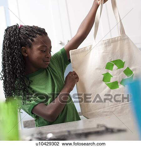 Young girl holding reusable shopping bag View Large Photo Image Stock Image - Young girl holding reusable shopping bag. Fotosearch